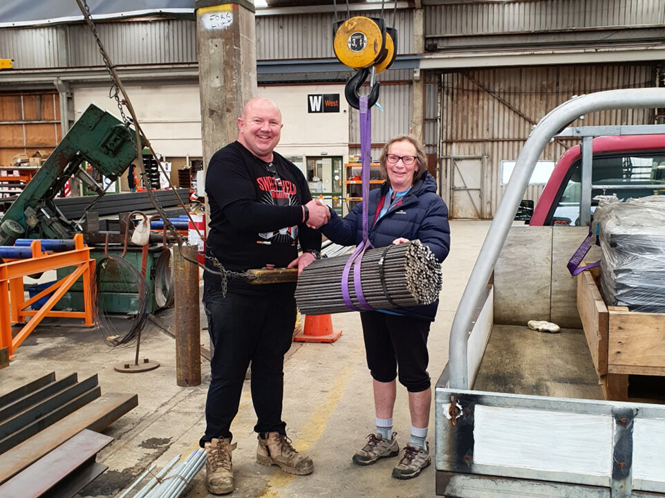Donation of Reo Stakes and Warratahs from Fletcher Steel’s Mike Mulligan to Lois Bishop from the Hokonui Tramping Club.