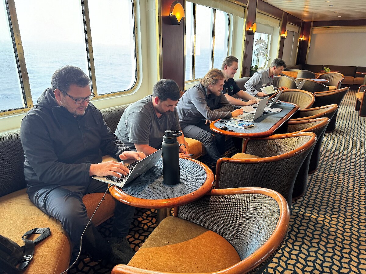 The Ngāi Tahu rōpu catching up on some mahi while at sea – Riki Parata, Karlee Nicholas, Luka Finn, Tāne Tamati. Photo credit Hokonui Rūnanga.