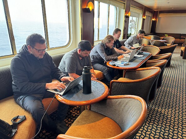 The Ngāi Tahu rōpu catching up on some mahi while at sea – Riki Parata, Karlee Nicholas, Luka Finn, Tāne Tamati. Photo credit Hokonui Rūnanga.